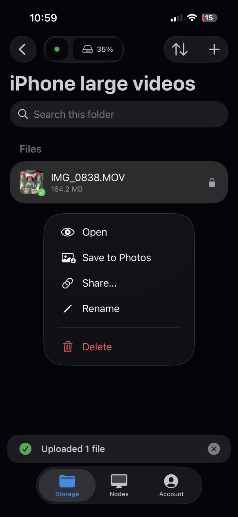 The video in Uncloud, encrypted, with Save to Photos in its menu and Uploaded 1 file below
